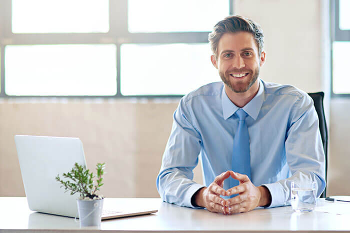 man with blue shirt and tie