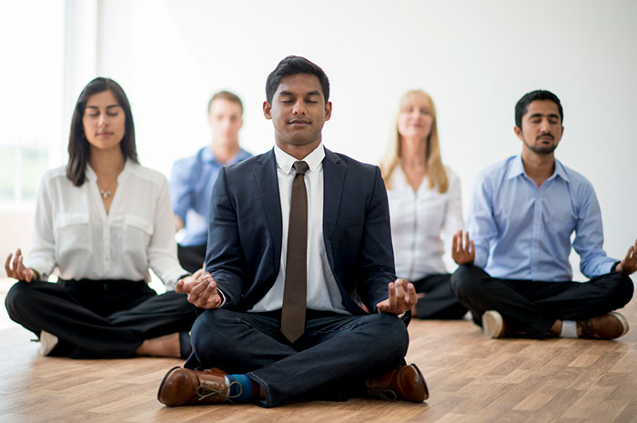 meditating business people